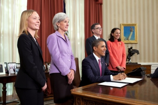 President Barack Obama talks with the media before signing an Executive Order directing the Food and Drug Administration (FDA) to take action to help further prevent and reduce prescription drug shortages, protect consumers and prevent price gouging, in the Oval Office, Oct. 31, 2011. From left: pharmacy manager Bonnie Frawley from Brigham and Women's Hospital in Boston, Mass.; Health and Human Services Secretary Kathleen Sebelius; cancer patient Jay Cuetara from San Francisco, Calif.; and FDA Commissioner Peggy Hamburg. (Official White House Photo by Pete Souza)