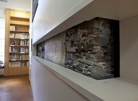 All about preservation. Architects left a portion of the original 1840 field stone wall exposed to give visitors to the Joukowsky Institute a glimpse of architectural history.