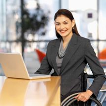business woman in wheelchair working on laptop