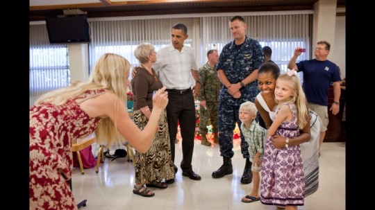 President Barack Obama and First Lady Michelle Obama greet service men and women, along with their families, during Christmas dinner in the mess at Marine Corps Base Hawaii in Kailua, Hawaii, Dec. 25, 2010. (Official White House Photo by Pete Souza)