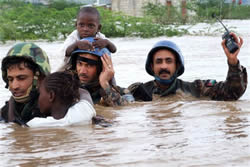Military personnel from the UN Stabilization Mission in Haiti (MINUSTAH) carrying victims of a hurricane through flood waters. UN Photo