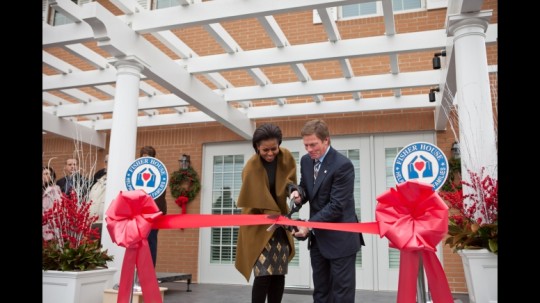 First Lady Michelle Obama and Ken Fisher, CEO of Fisher House, participate in a ribbon cutting ceremony at Bethesda National Naval Medical Hospital in Bethesda, Md., Dec. 2, 2010. The First Lady helped open three new Fisher House residences for families of ailing U.S. soldiers and veterans. The news residences provide free lodging for the families of as many as 60 sick and injured service members. (Official White House Photo by Samantha Appleton)