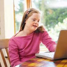 teenage girl with downsyndrome working on laptop